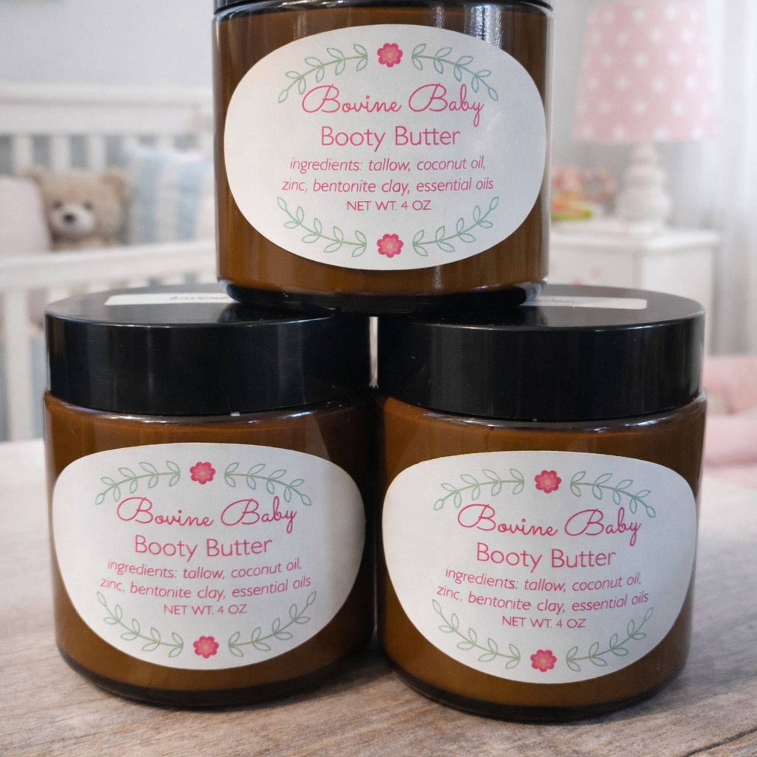 bovine beauty tallow baby booty butter on wood bench and baby room blurred in background