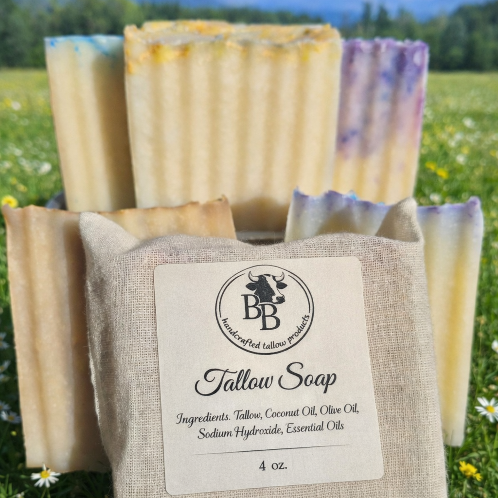 Tallow soap bars with a bovine beauty tallow label on grass with mountains in the background